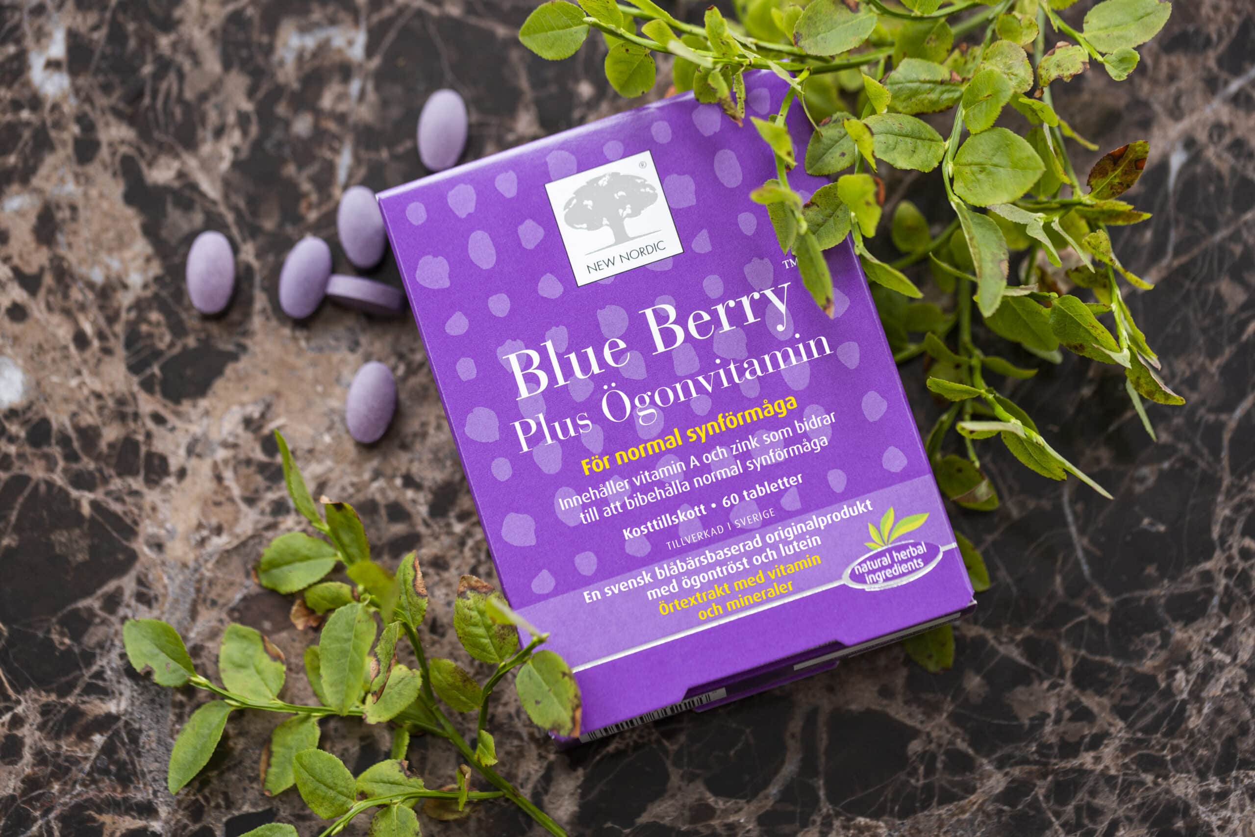 Blue Berry package and tablets surrounded by forest